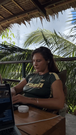 Woman works on laptop during early morning in General Luna