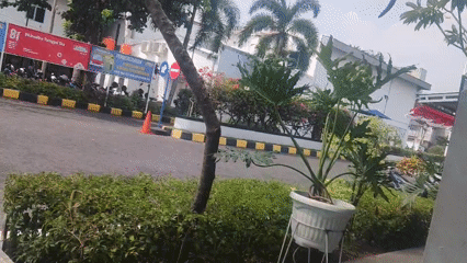 Green courtyard, parked bikes, and a social shoutout in Trihanggo