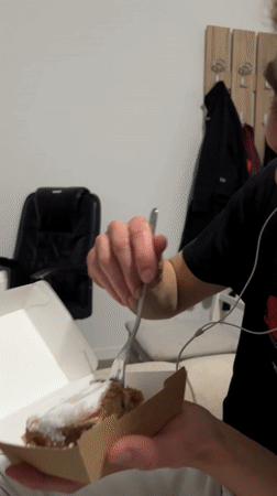 Man enjoys pastry with fork in Montenegro coastal town