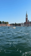Motorboat crossing the Venice lagoon on a clear afternoon
