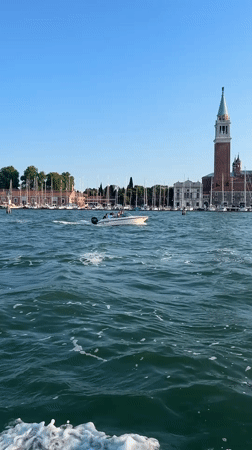 Motorboat crossing the Venice lagoon on a clear afternoon