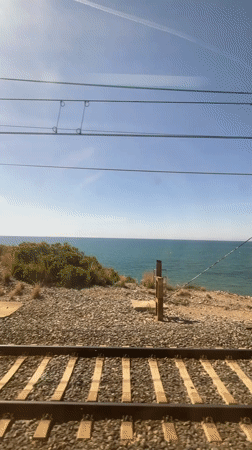 Coastal train journey with violin passenger documented near Sitges