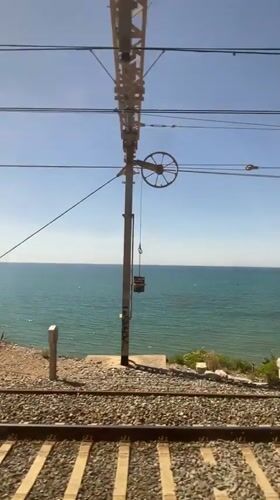 Coastal train journey with violin passenger documented near Sitges