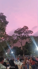 Evening street life and hillside neighborhoods across Caracas