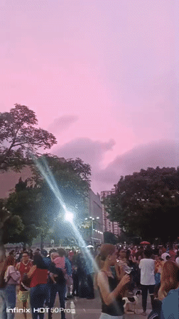 Evening street life and hillside neighborhoods across Caracas