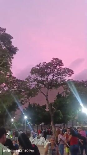 Evening street life and hillside neighborhoods across Caracas