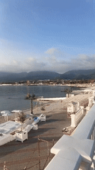 Woman walks beachside walkway at Novorossiysk resort