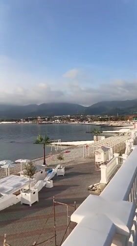 Woman walks beachside walkway at Novorossiysk resort