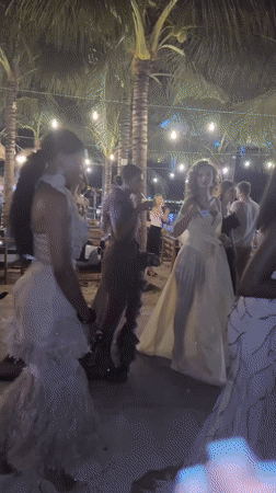 Formal outdoor evening gathering under string lights in Nha Trang