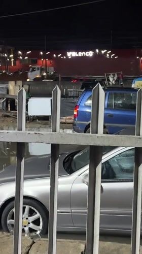 Nighttime scenes in Lagos include flooded Mercedes, illuminated Burger King