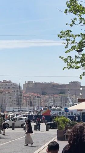Woman enjoys lunch at Marseille waterfront cafe