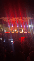 Live band plays a colorfully lit outdoor concert in Tavira