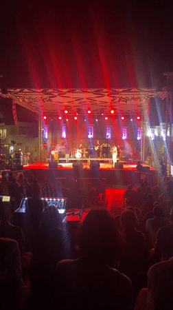 Live band plays a colorfully lit outdoor concert in Tavira