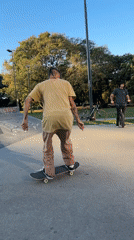 Skateboarder performs tricks at Buenos Aires concrete park