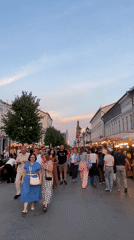 Evening crowd strolls Kazan pedestrian street at sunset