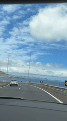 Highway travel along Portuguese coast offers scenic island views
