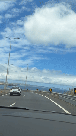 Highway travel along Portuguese coast offers scenic island views