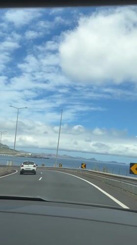 Highway travel along Portuguese coast offers scenic island views