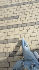 Woman Takes Selfie While Walking in Urban Area