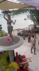 Woman dances on record platform at Thailand beach party