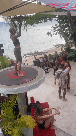 Woman dances on record platform at Thailand beach party