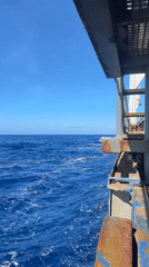 Ocean voyage documented from ship deck on sunny day