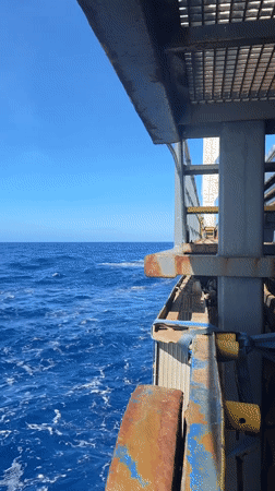 Ocean voyage documented from ship deck on sunny day