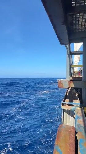 Ocean voyage documented from ship deck on sunny day