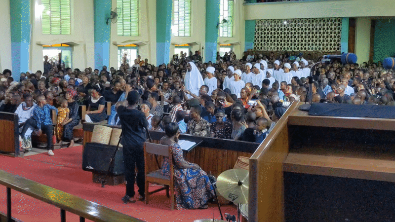 Church ceremony with robed attendees documented in Moshi, Tanzania