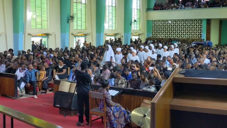 Church ceremony with robed attendees documented in Moshi, Tanzania