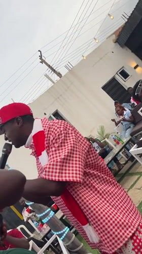 Arsenal fans celebrate outdoors in Gura Top, Nigeria