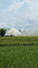 Material pile burns in Indonesian rice field near Kediri