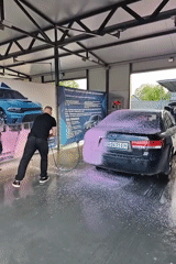 Man washes black sedan at Hadiach car wash