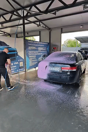 Man washes black sedan at Hadiach car wash