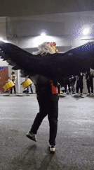Costumed street performers dance with musicians in Iquique nighttime event