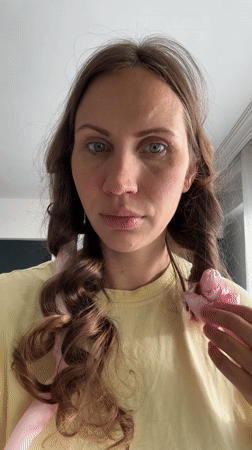 Woman styles hair with curling rods in Fethiye