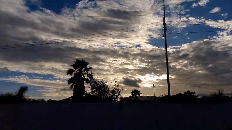 Sunlight breaks through clouds over La Tagua's silhouetted skyline