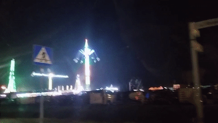 Carnival rides and fireworks light up a summer night in Warka