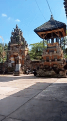 Balinese temple complex with gates, statues, and ceremonial structures