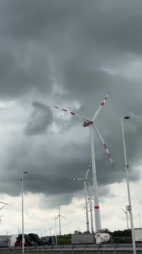 Wind turbines observed under cloudy skies in Parndorf, Austria
