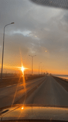 Sunset drive captured along bridge road in Chaikovsky, Russia