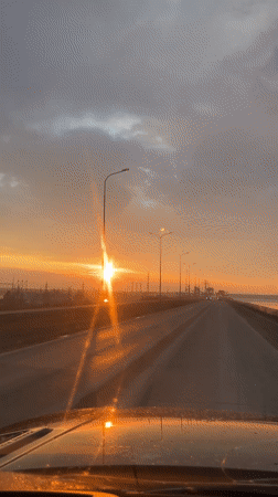 Sunset drive captured along bridge road in Chaikovsky, Russia