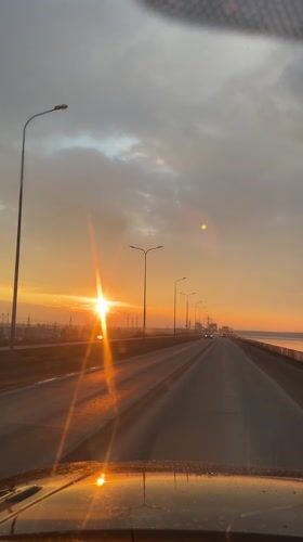 Sunset drive captured along bridge road in Chaikovsky, Russia