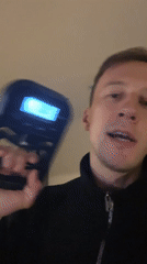 Man tests grip strengthener near decorated money tree in Russia
