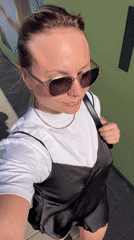 Woman films selfie video on sunny Bat Yam sidewalk