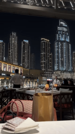 Outdoor restaurant dining captured against Dubai's illuminated skyline