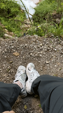 Person rests on rocky ground in Montenegro