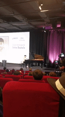 Pianist performs music lesson presentation in Cannes theater venue
