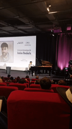 Pianist performs music lesson presentation in Cannes theater venue