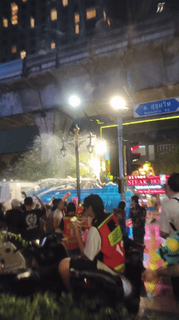 Bangkok street crowds celebrate Songkran with water truck festivities